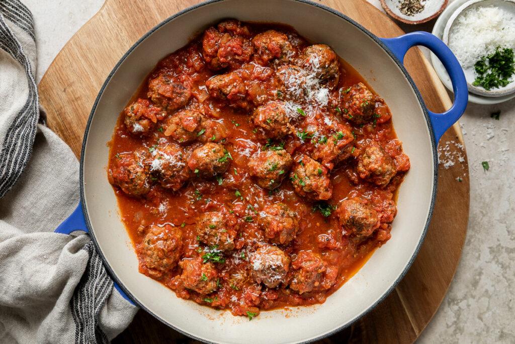 A pan of gluten-free meatballs ina. tomato sauce.