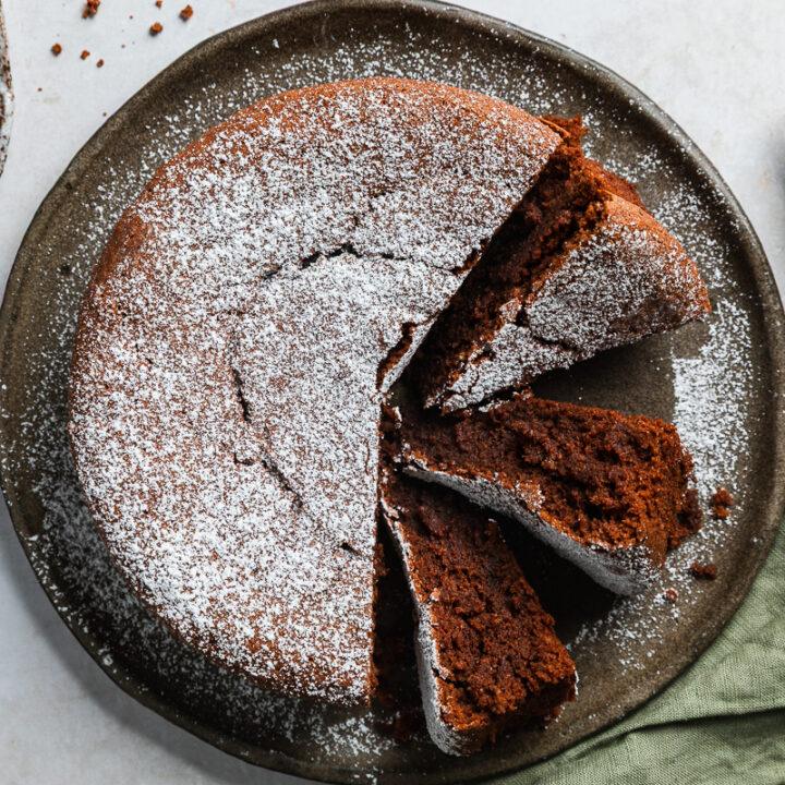 Overhead photo of Italian flourless chocolate cake with three slices on their side to show the texture.