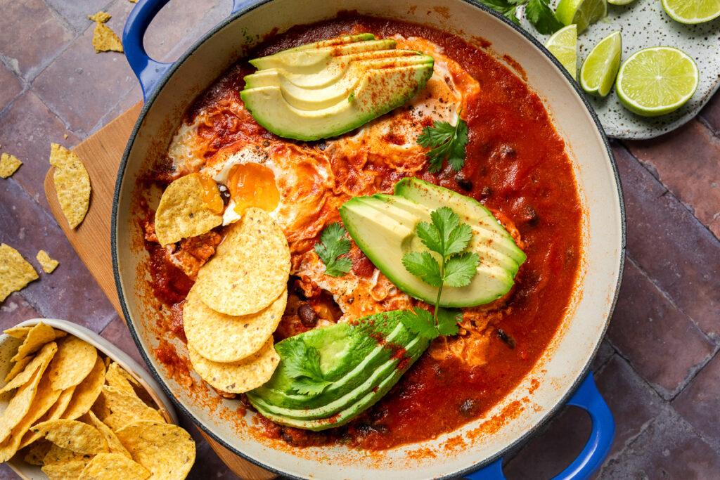 A pan of baked eggs with corn chips.