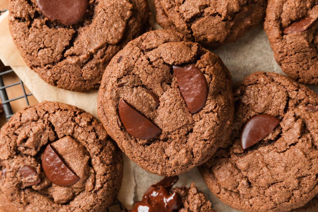 Close up of a pile of double choc chip cookies.
