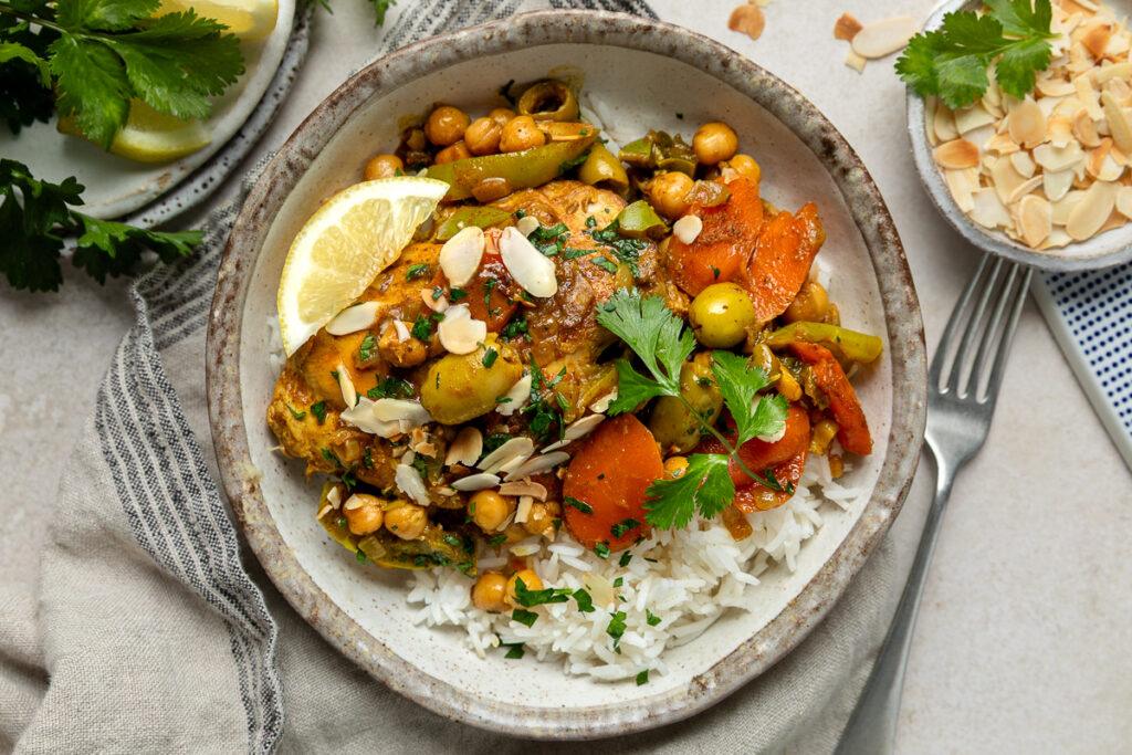 a bowl of chicken tagine served with rice.
