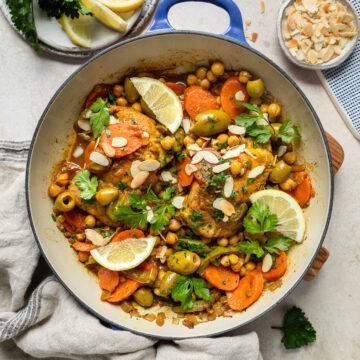 A pan of gluten-free chicken tagine with chickpeas and olives.
