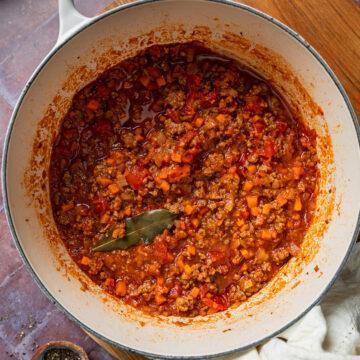 A pan of homemade savoury beef mince in a rich tomato sauce.