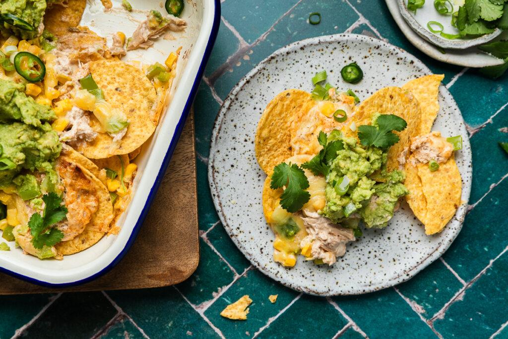 A plate of tuna nachos next to the dish they were baked in.