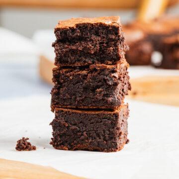 A stack of three gluten-free chocolate brownies.