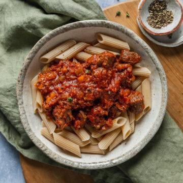 A bowl of homemade beef ragu served on gluten-free pasta.