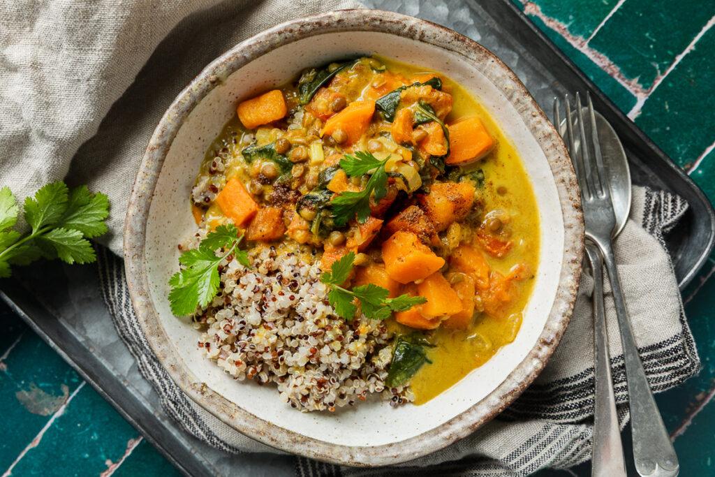 A bowl of sweet potato dahl served with quinoa.
